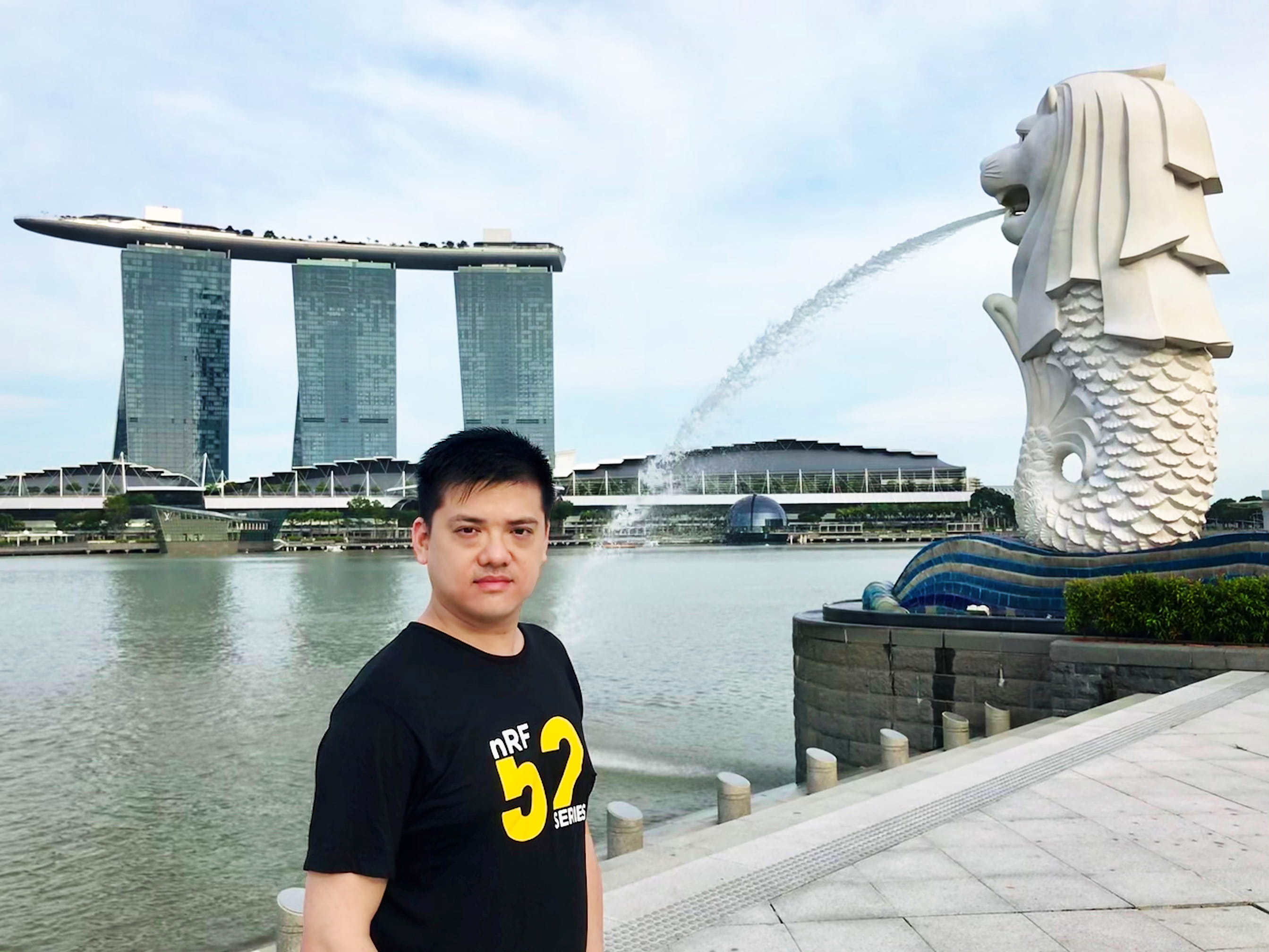a man standing in front of a body of water