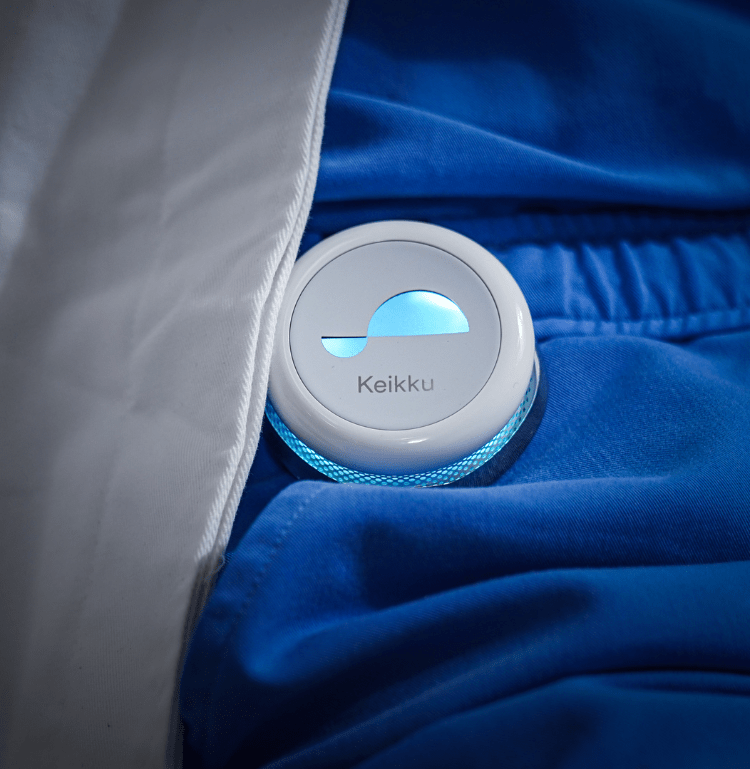 indoor bed sitting blue small remote blanket control close laying holding game man bag